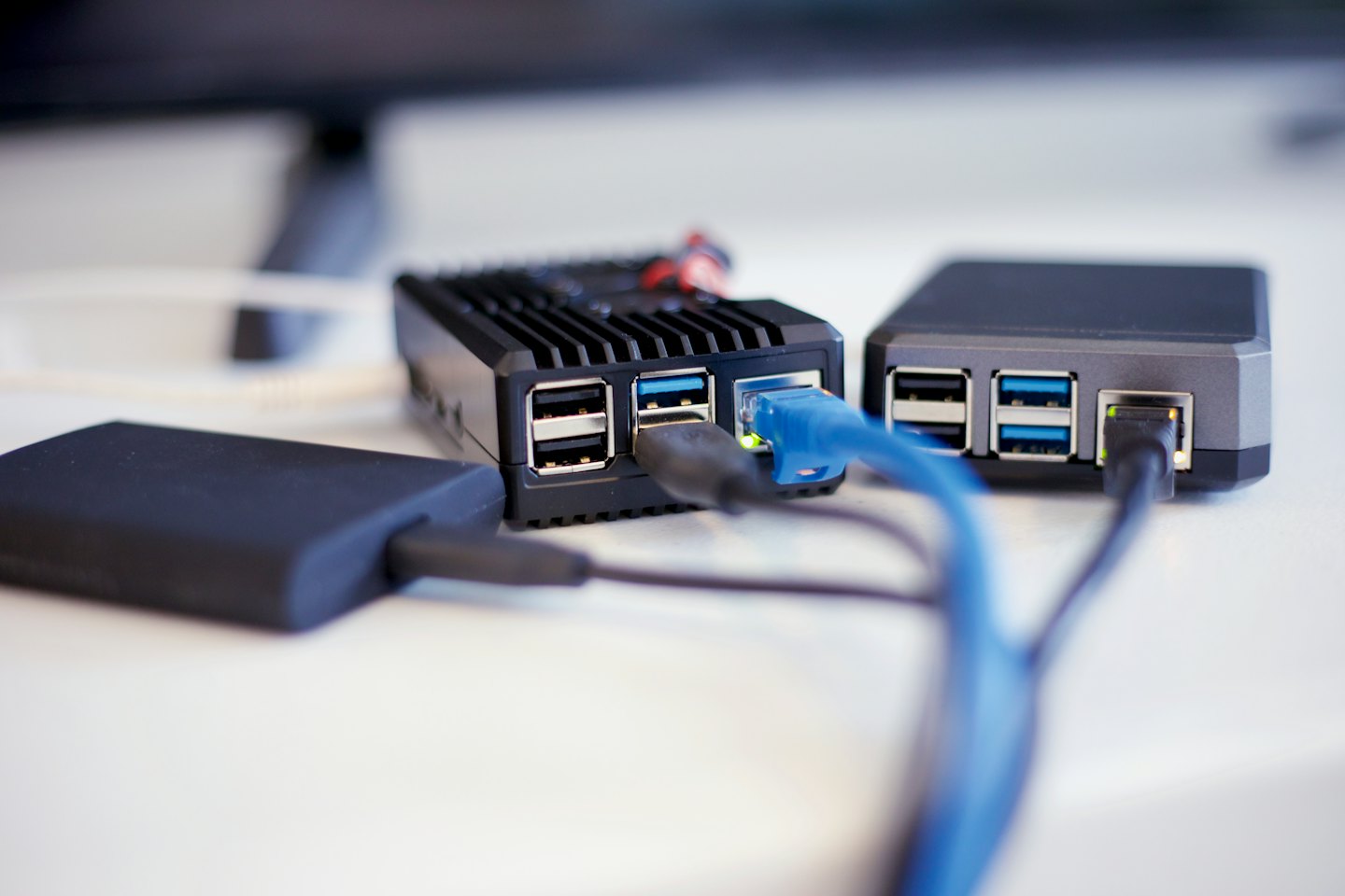 Several small black computer devices connected with cables.